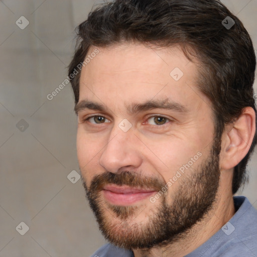 Joyful white adult male with short  brown hair and brown eyes