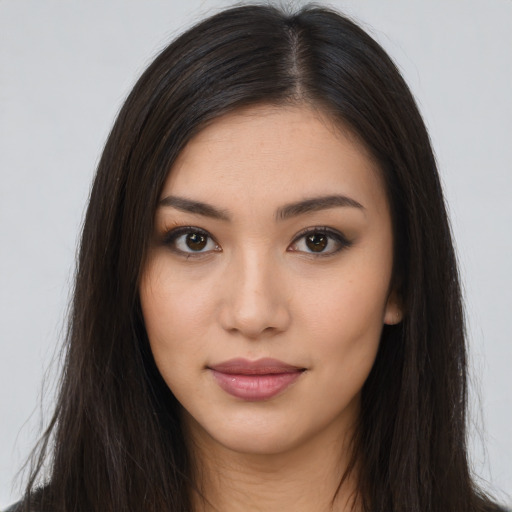 Joyful latino young-adult female with long  brown hair and brown eyes