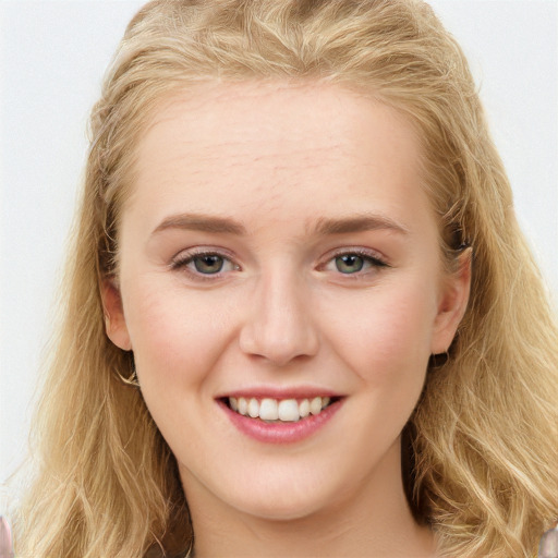 Joyful white young-adult female with long  brown hair and blue eyes