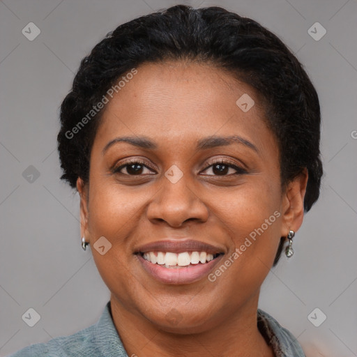 Joyful black young-adult female with short  brown hair and brown eyes