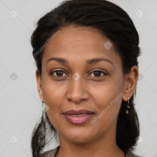 Joyful black adult female with medium  brown hair and brown eyes