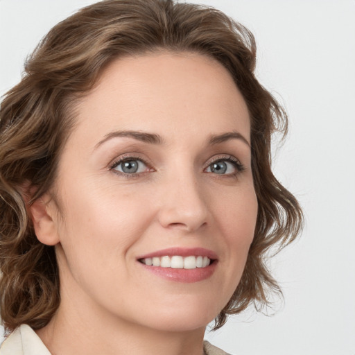 Joyful white young-adult female with medium  brown hair and green eyes