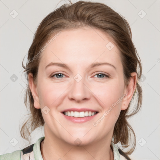 Joyful white adult female with medium  brown hair and blue eyes