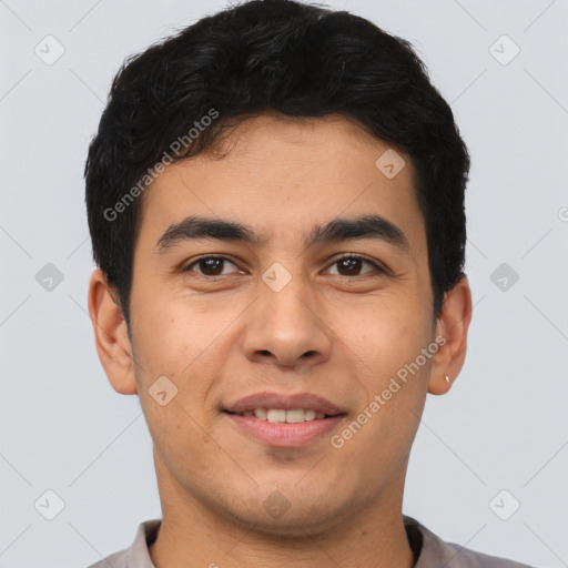 Joyful latino young-adult male with short  brown hair and brown eyes