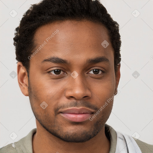 Joyful black young-adult male with short  brown hair and brown eyes