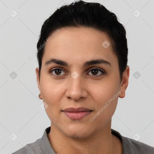 Joyful latino young-adult female with short  black hair and brown eyes