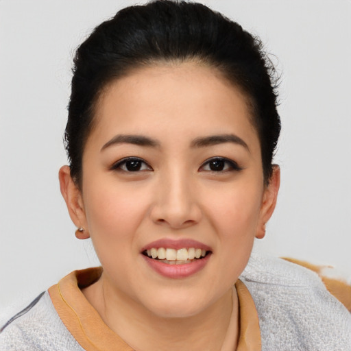 Joyful asian young-adult female with short  brown hair and brown eyes