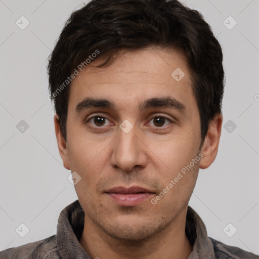 Joyful white adult male with short  black hair and brown eyes