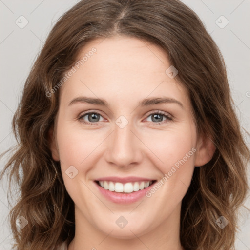 Joyful white young-adult female with medium  brown hair and green eyes