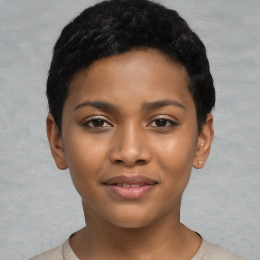 Joyful black child female with short  black hair and brown eyes