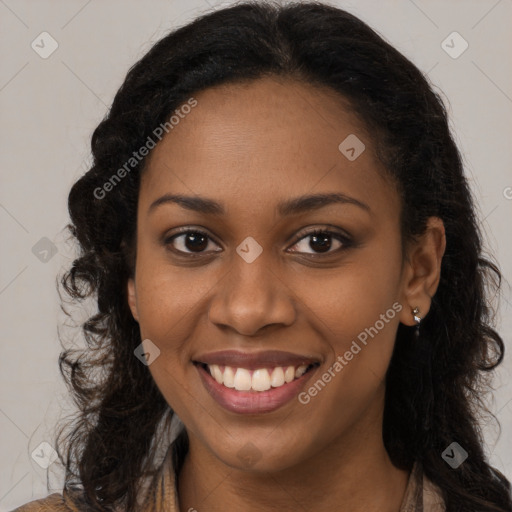 Joyful black young-adult female with long  brown hair and brown eyes