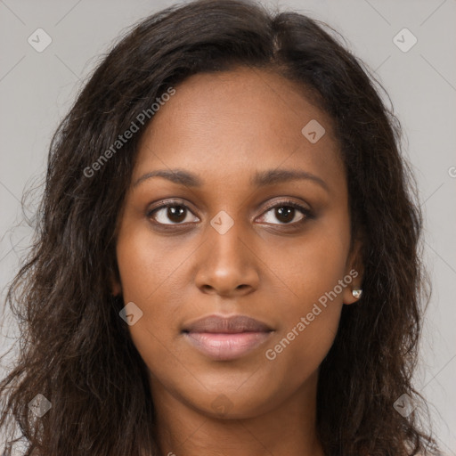 Joyful black young-adult female with long  brown hair and brown eyes