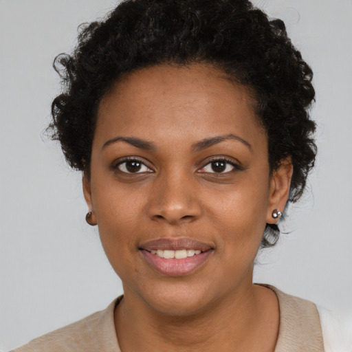 Joyful black young-adult female with short  brown hair and brown eyes
