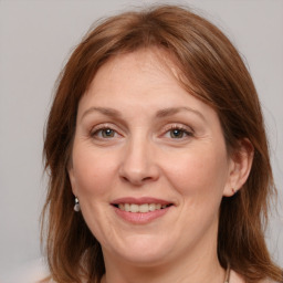 Joyful white adult female with medium  brown hair and grey eyes