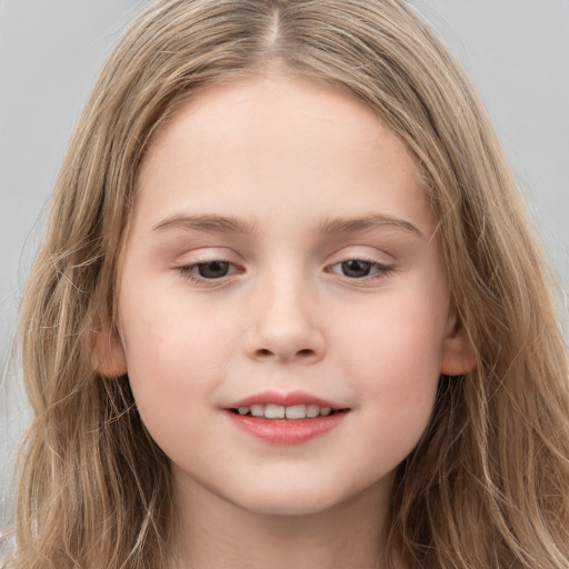 Joyful white child female with long  brown hair and brown eyes