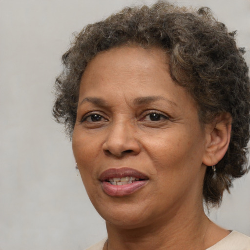 Joyful black adult female with short  brown hair and brown eyes