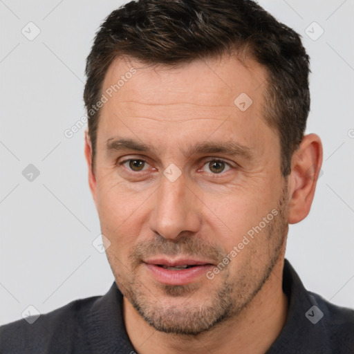 Joyful white adult male with short  brown hair and brown eyes