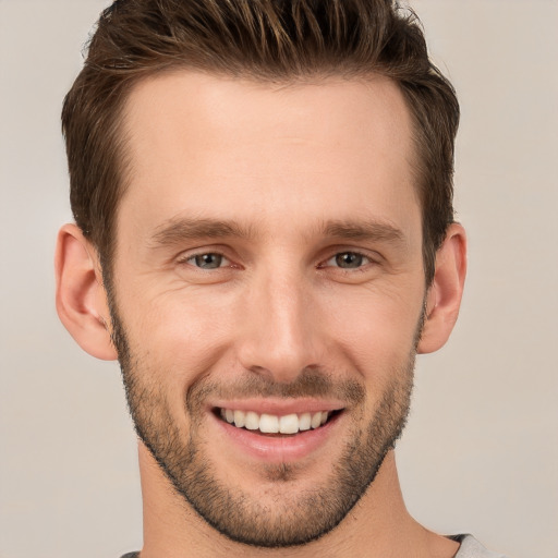 Joyful white young-adult male with short  brown hair and brown eyes