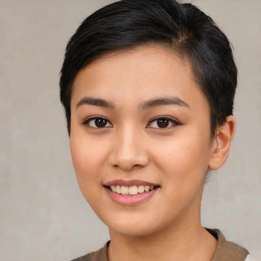 Joyful asian young-adult female with short  brown hair and brown eyes