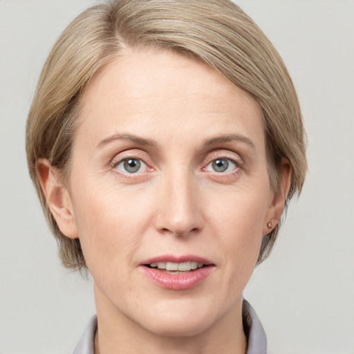 Joyful white adult female with medium  brown hair and blue eyes