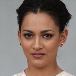 Joyful latino young-adult female with short  brown hair and brown eyes