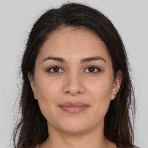 Joyful white young-adult female with long  brown hair and brown eyes