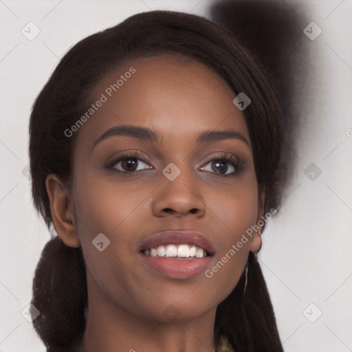 Joyful black young-adult female with long  brown hair and brown eyes