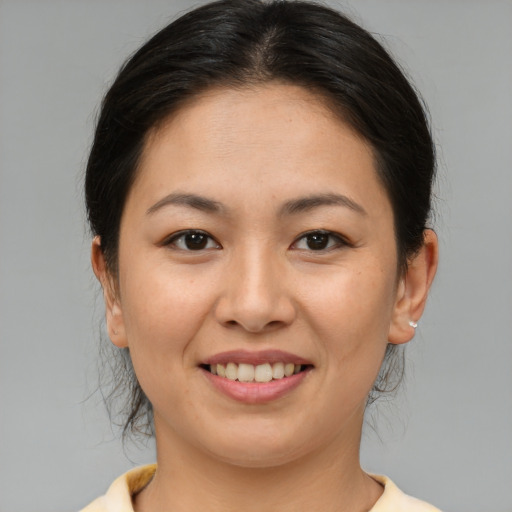 Joyful asian young-adult female with medium  brown hair and brown eyes