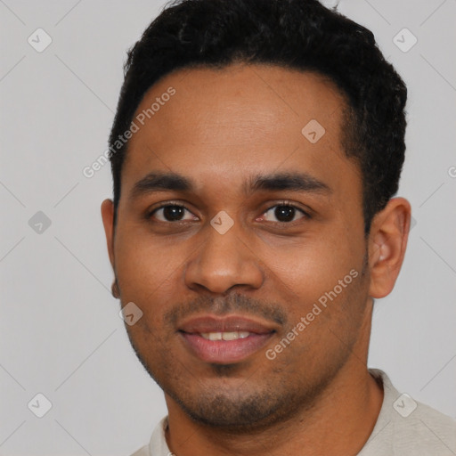 Joyful black young-adult male with short  black hair and brown eyes