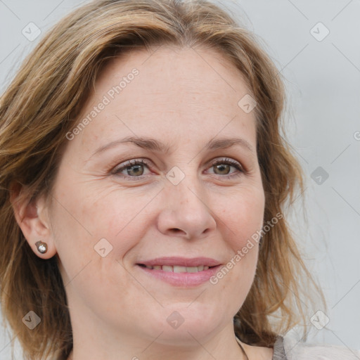 Joyful white adult female with medium  brown hair and blue eyes