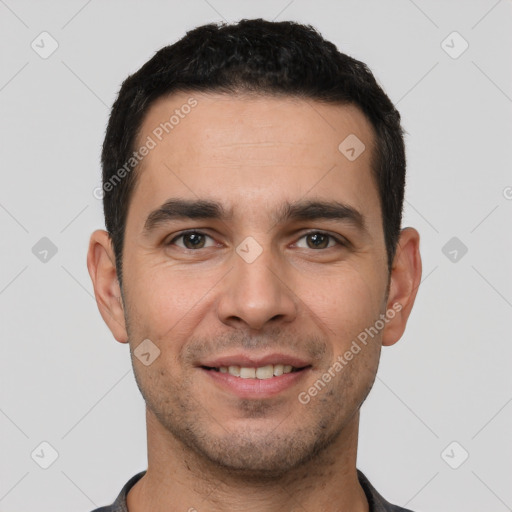 Joyful white young-adult male with short  black hair and brown eyes