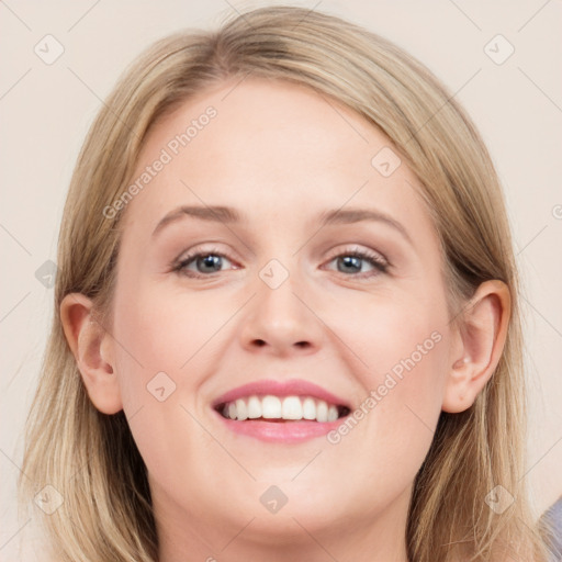 Joyful white young-adult female with long  brown hair and blue eyes