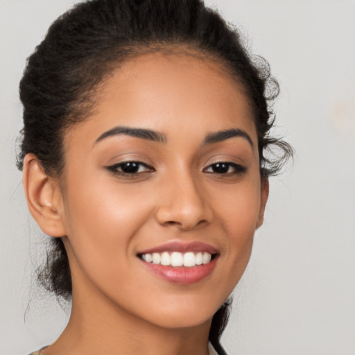 Joyful latino young-adult female with long  brown hair and brown eyes