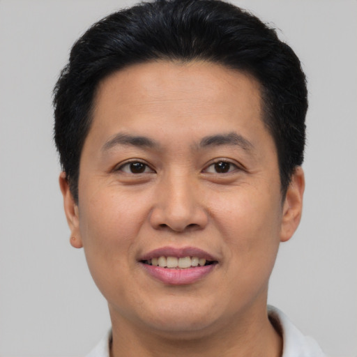 Joyful asian young-adult male with short  brown hair and brown eyes