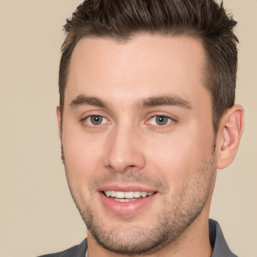 Joyful white young-adult male with short  brown hair and brown eyes