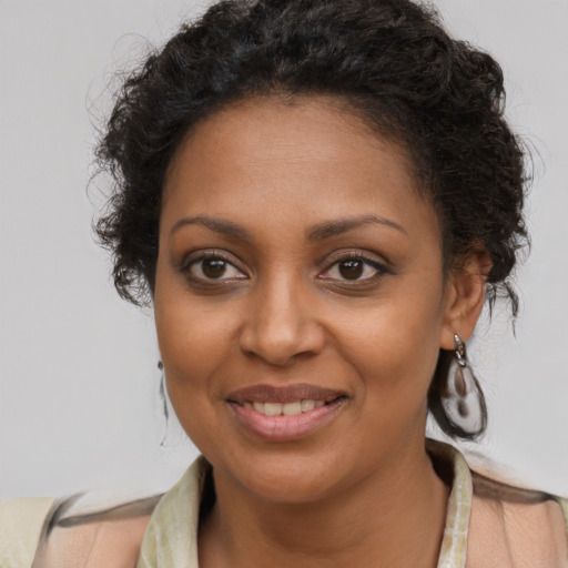 Joyful black young-adult female with medium  brown hair and brown eyes