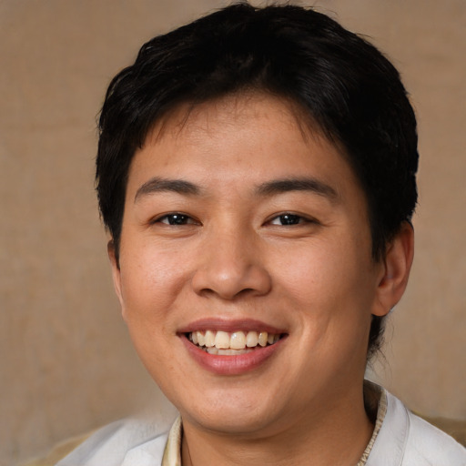 Joyful asian young-adult female with short  brown hair and brown eyes