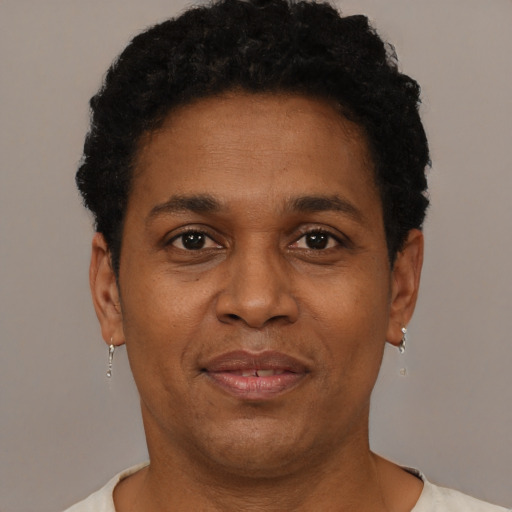 Joyful black adult male with short  brown hair and brown eyes