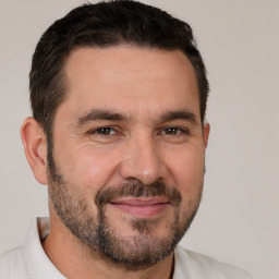 Joyful white adult male with short  brown hair and brown eyes