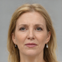 Joyful white adult female with long  brown hair and grey eyes