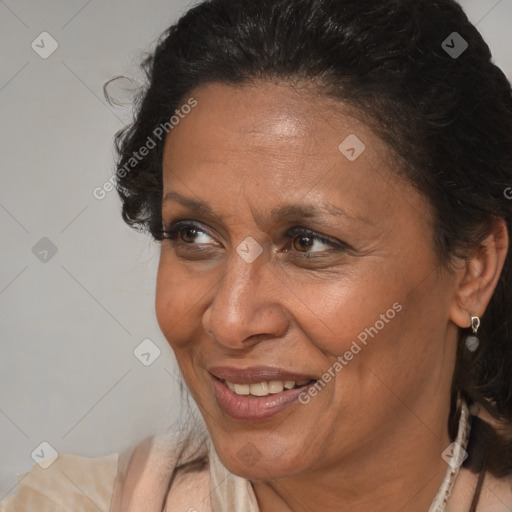 Joyful black adult female with medium  brown hair and brown eyes