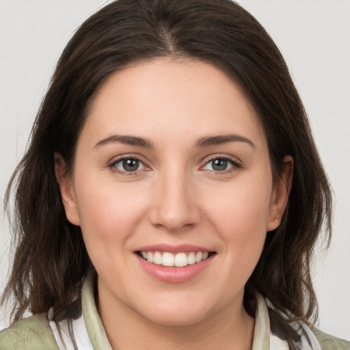 Joyful white young-adult female with medium  brown hair and brown eyes