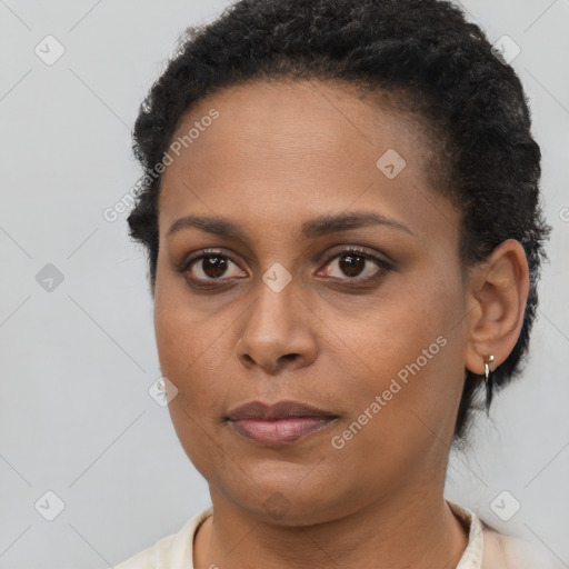 Joyful black young-adult female with short  brown hair and brown eyes