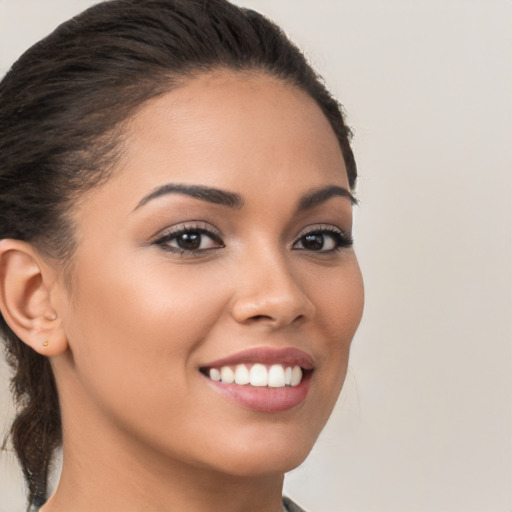 Joyful latino young-adult female with long  brown hair and brown eyes