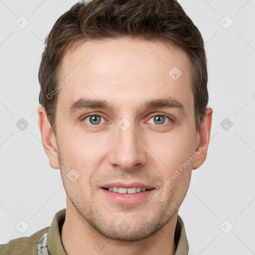 Joyful white young-adult male with short  brown hair and grey eyes