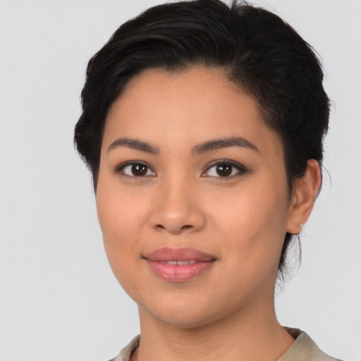 Joyful latino young-adult female with medium  black hair and brown eyes