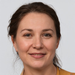 Joyful white adult female with medium  brown hair and brown eyes