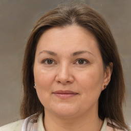 Joyful white adult female with medium  brown hair and brown eyes