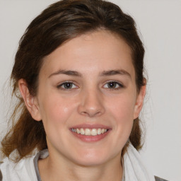 Joyful white young-adult female with medium  brown hair and blue eyes