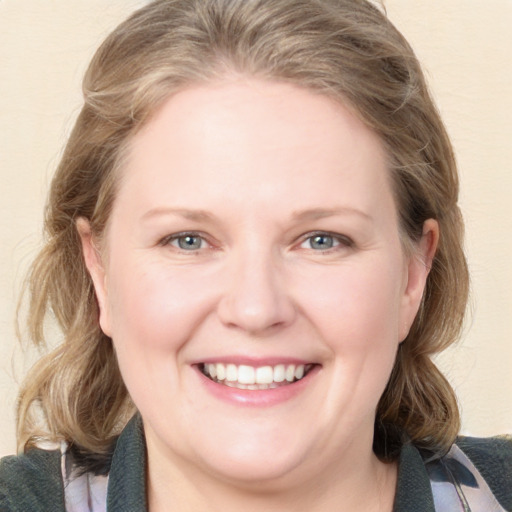 Joyful white young-adult female with medium  brown hair and blue eyes